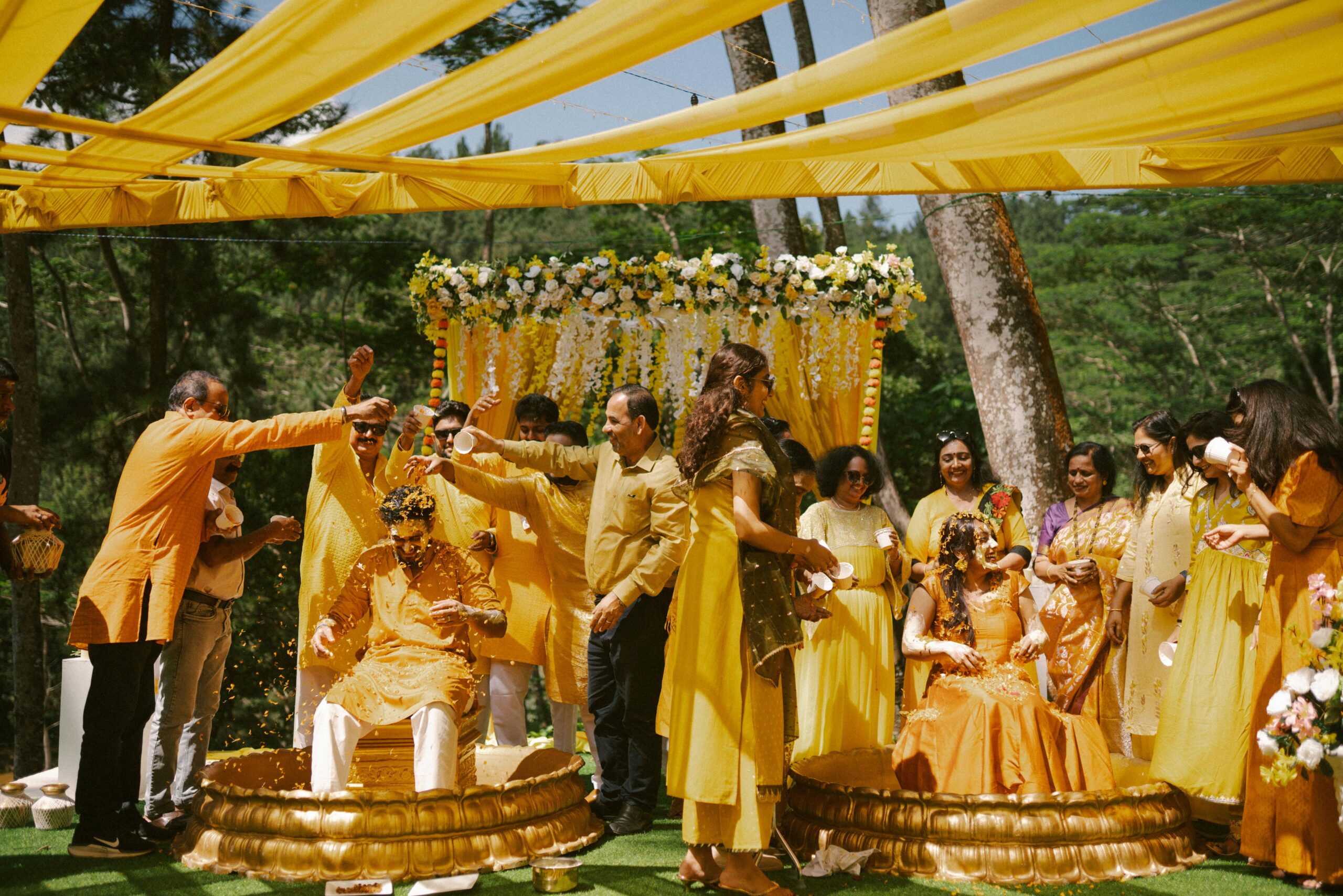 A traditional Indian wedding with vibrant yellow decor and joyful participation.